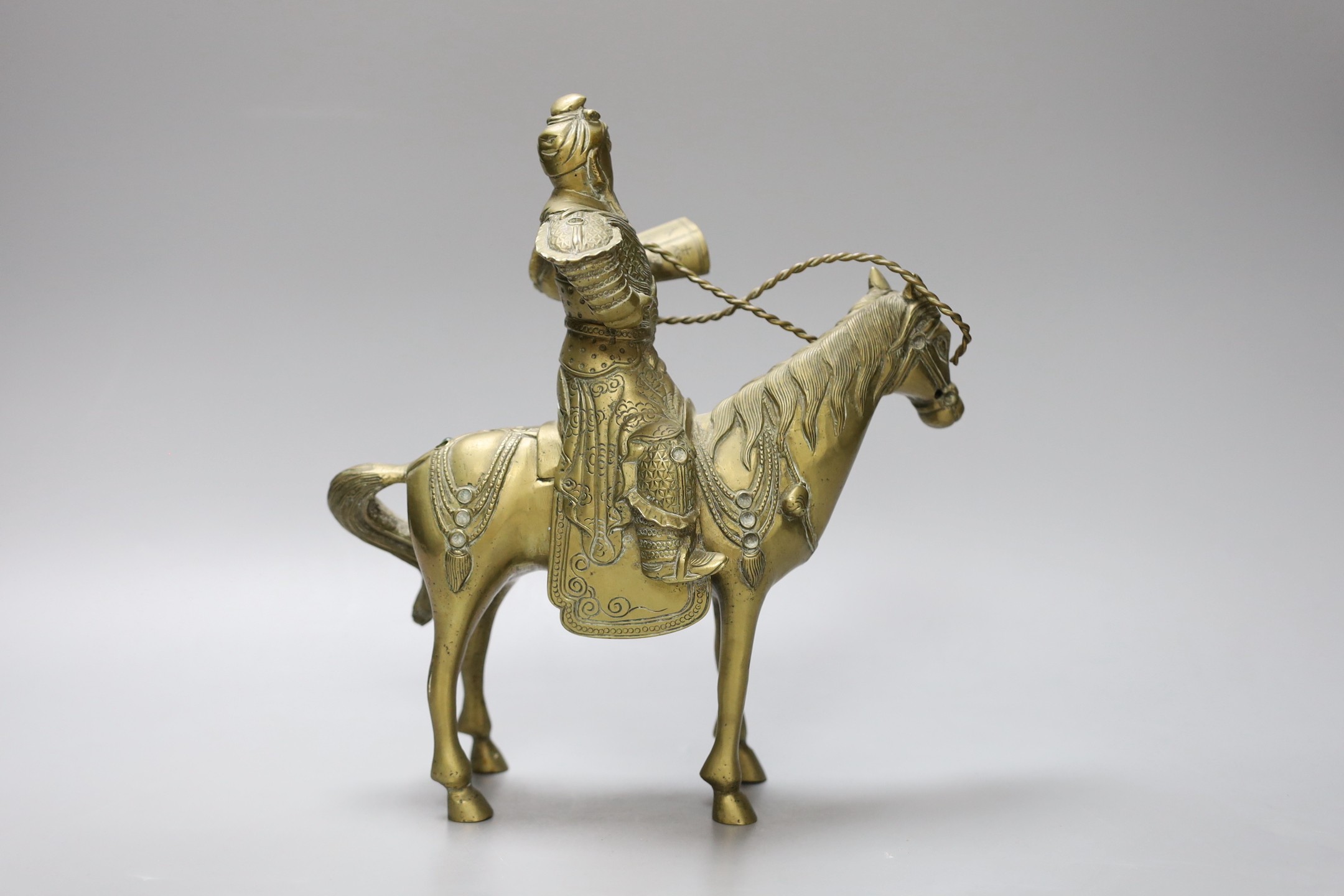 An early 20th century Chinese bronze group of Guandi riding a horse, 24 cms high